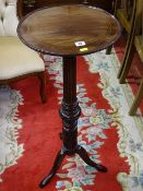 A VICTORIAN CARVED MAHOGANY TORCHERE, 89 cms high, 37 cms diameter top