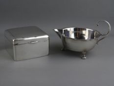 A SILVER THREE FOOTED SHALLOW CREAM JUG & A SILVER SQUARE CEDAR LINED CIGARETTE BOX, Sheffield 1905,
