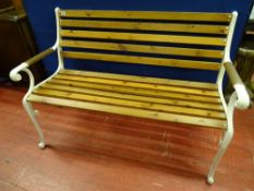A FULLY RESTORED GARDEN BENCH with slatted seat and back on cast iron ends, 83.5 cms high, 123 cms