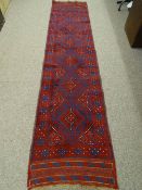 A MESHWANI CARPET RUNNER, red and blue ground, single bordered with repeating diamond central
