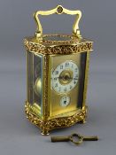 A GOOD 20th CENTURY FRENCH PIERCED GILT BRASS CARRIAGE ALARM CLOCK having a circular enamel dial and