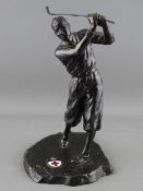 A VINTAGE CAST METAL FIGURE OF A GOLFER, the base set with an oval enamel plaque showing the emblems