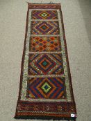 A SUZNI KILIM CARPET RUNNER having colourful double bordered panels, 189 x 63 cms