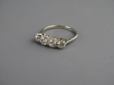 AN EIGHTEEN CARAT WHITE GOLD & PLATINUM FOUR STONE DIAMOND RING, size 'N', 2.9 grms gross