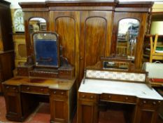 A VICTORIAN MAHOGANY BEDROOM SUITE comprising an impressive breakfront wardrobe having two centre