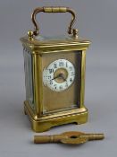 A FRENCH MINIATURE BRASS CASED CARRIAGE CLOCK, the circular enamel dial with Arabic numerals and