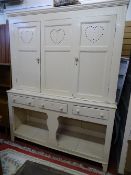 AN INTERESTING CREAM PAINTED PINE HOUSEKEEPER'S CUPBOARD, the upper section having two panelled