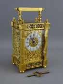 A 19th CENTURY FRENCH GILT BRASS CARRIAGE CLOCK having fluted column sides with cap finials, the