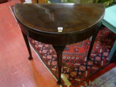 A VINTAGE MAHOGANY HALF MOON FOLDOVER CARD TABLE with baize lined interior, on slender shaped