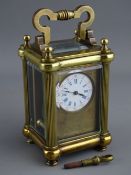 A FRENCH MINIATURE BRASS CASED CARRIAGE CLOCK, the plain gilt mask showing a circular dial with blue