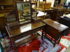 AN EDWARDIAN MIRRORED DRESSING TABLE with under tier shelf and an oak twin flap barley twist gate