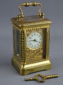 A FRENCH MINIATURE BRASS CASED CARRIAGE CLOCK, the case with pierced leaf canted corners, phoenix