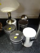 A collection of small pedal bins together with a brass effect table lamp