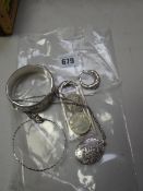 A bright cut silver bangle, silver locket, two coins etc