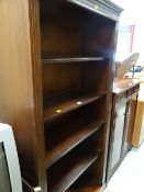 A reproduction dark wood tall open bookcase