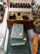 A cased homeopathy set & an album of vintage postcards etc