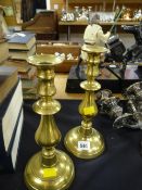 A pair of nineteenth century circular base brass candle holders
