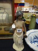 A Lladro matte finish figure of a semi-clad water carrying maiden, no.2323