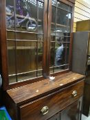 An antique secretaire bookcase with drop down desk & two-door glazed bookcase top