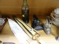 A pair of novelty parasols together with two flat irons & a bottle containing a model of a cross
