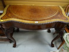 A good reproduction side table with tooled leather top