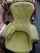 A walnut spoon backed armchair with green button backed upholstery