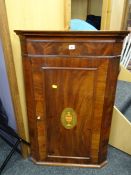 A quality antique mahogany hanging corner cupboard with Sheraton-type decoration