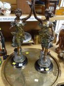A good pair of spelter figures on turned wood bases together with a large brass profusely