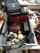 A box of ornamental mineral eggs & sundry camera equipment