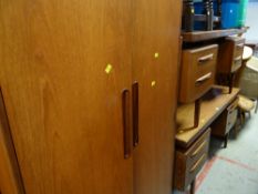 A G-Plan two-door wardrobe & a matching pair of G-Plan dressing tables & headboard