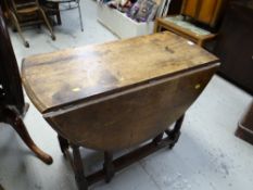 An antique drop leaf gateleg table