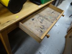 A lightwood school desk with drawer (profusely graffitied by former pupils)