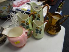 A trio of Carltonware jugs, copper lustre jug etc