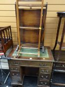 A compact kneehole desk with tooled green leather top together with a jacket suit stand & fire