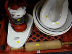 A crate of items including a large wooden rolling pin, two slipper bed pans including one for