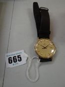 An Omega 9ct gold gents wristwatch with date aperture