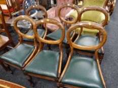 A set of six mahogany balloon backed dining chairs with leatherette drop in seats