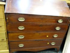 An antique mahogany four-drawer bureau with unusual brass animal head decorated handles
