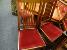 A set of four mahogany spindle back & cushion seated dining chairs