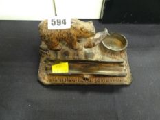 A metallic desk stand in the form of bear with fish on a naturalistic base