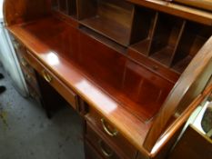 A reproduction Far Eastern hardwood drum-style writing desk