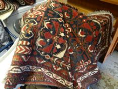 A blue & red ground patterned Persian woollen rug