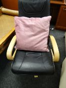 A modern beech framed & black leather effect revolving armchair