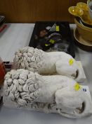 Pair of ornamental reclining lions & a display of fossils & minerals