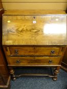 A vintage sloped two-drawer bureau