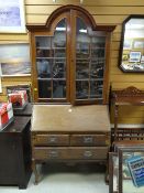 A dome top three-drawer bureau bookcase