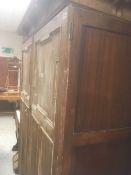 A stripped back two-door vintage pine wardrobe