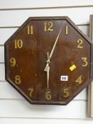 A vintage octagonal wooden wall clock