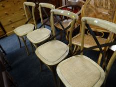 A set of four modern rattan seated & X metal backed dining chairs