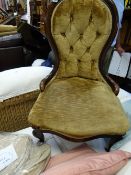 An antique carved decorated Victorian mahogany button back upholstered bedroom chair
